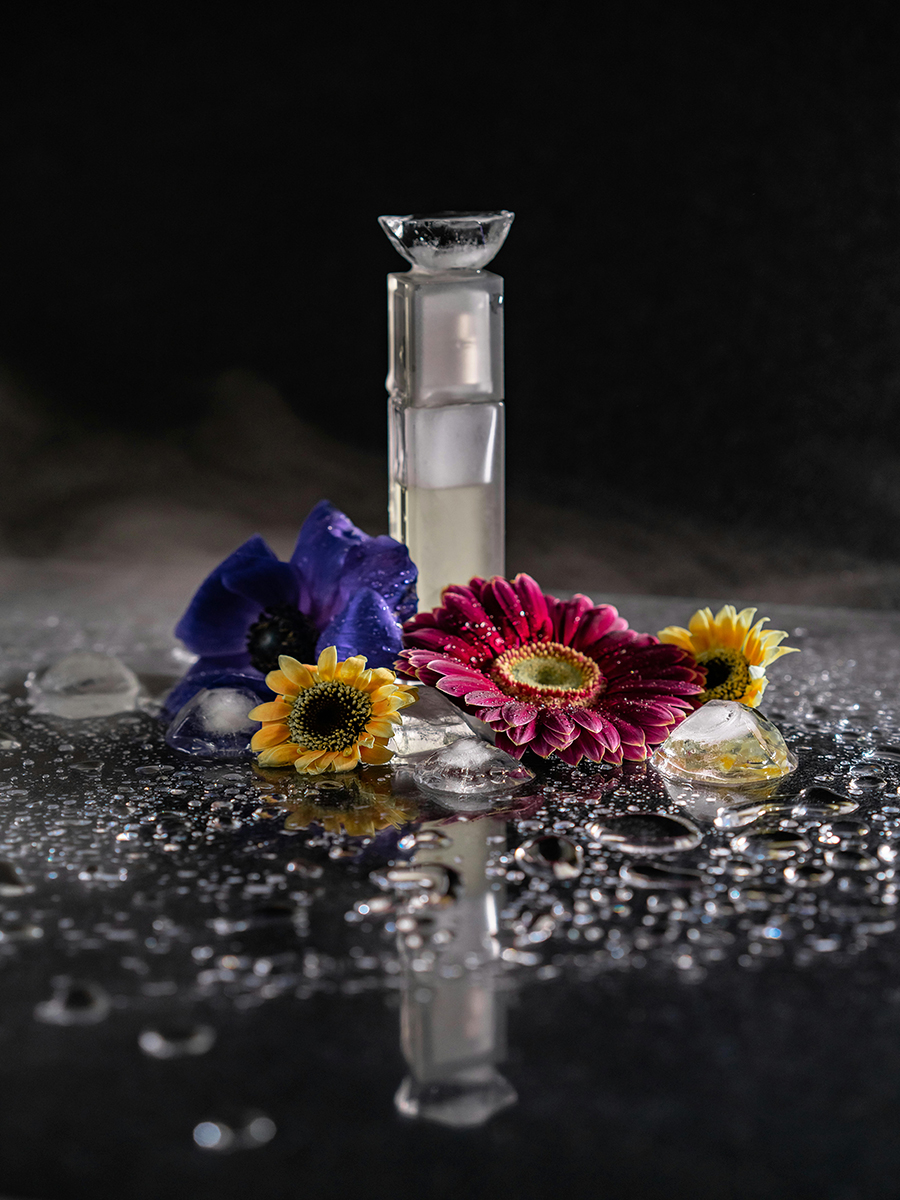 small perfume bottle with water splash