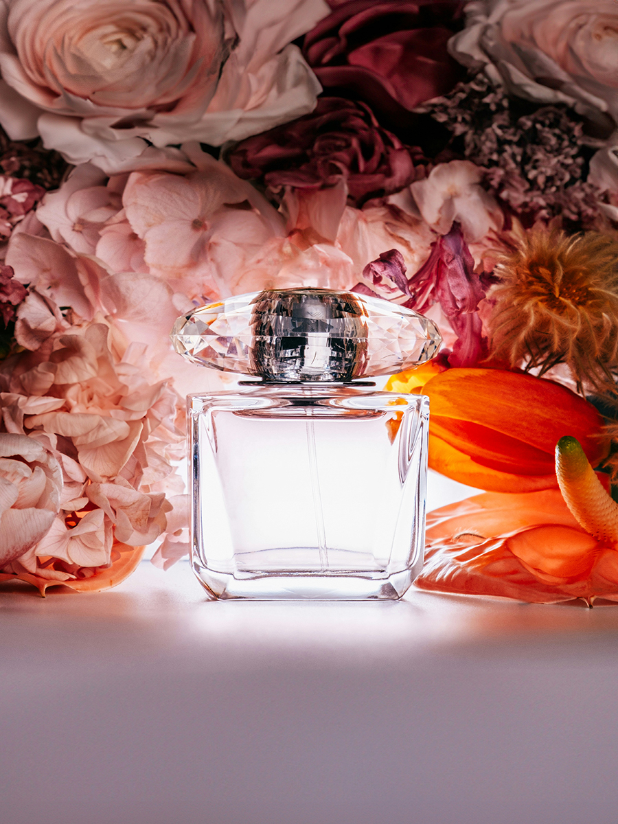 perfume bottle with flowers on the background